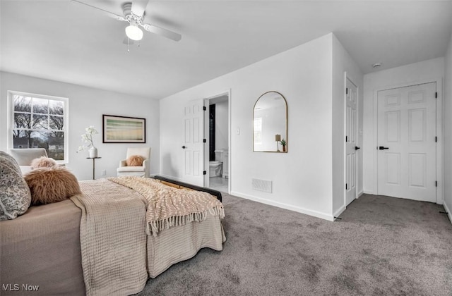 bedroom with a ceiling fan, baseboards, carpet, and ensuite bath