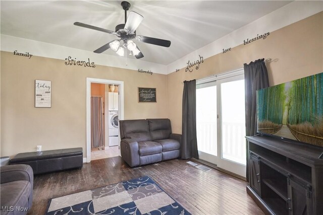 living room featuring washer / clothes dryer, ceiling fan, visible vents, and wood finished floors