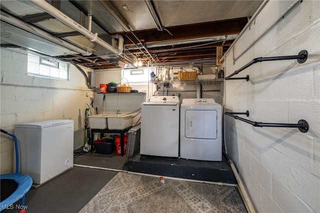 laundry area featuring laundry area, a sink, and washer and clothes dryer