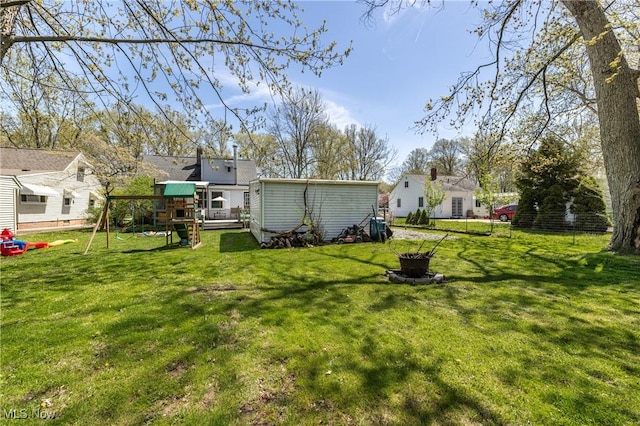view of yard featuring a playground and fence