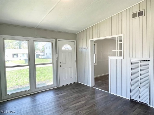 entryway with wood walls, visible vents, and plenty of natural light