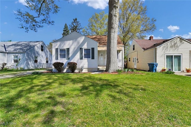 rear view of property with a yard