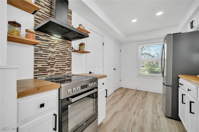 4392 E 144th St, Cleveland, OH 44128 - kitchen with open shelves, stainless steel appliances, wall chimney range hood, wooden counters, and light wood-style flooring