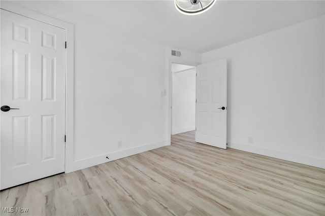 4392 E 144th St, Cleveland, OH 44128 - unfurnished bedroom with wood finished floors and baseboards