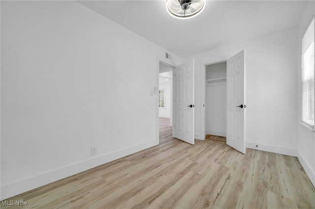 4392 E 144th St, Cleveland, OH 44128 - unfurnished bedroom featuring wood finished floors, baseboards, and a closet