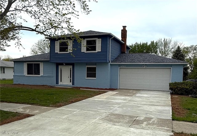 view of front facade with a front lawn, roof with shingles, a chimney, an attached garage, and driveway