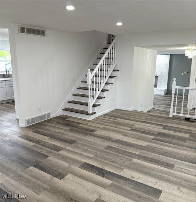 interior space featuring baseboards, visible vents, and wood finished floors