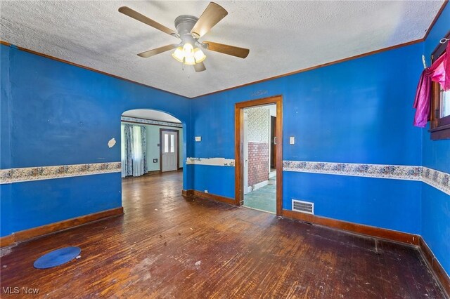 empty room with wood-type flooring, a textured ceiling, and visible vents
