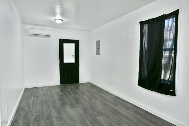 1553 Parkman Rd NW, Warren, OH 44485 - foyer entrance featuring baseboards, a wall mounted AC, dark wood finished floors, and electric panel