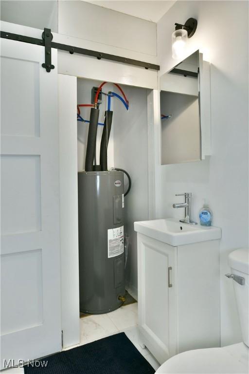1553 Parkman Rd NW, Warren, OH 44485 - half bath featuring vanity, marble finish floor, toilet, and electric water heater