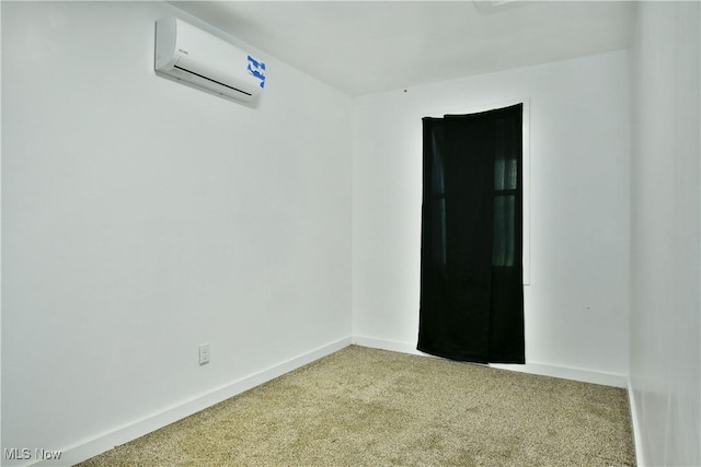 carpeted spare room with baseboards and a wall mounted air conditioner