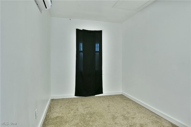 1553 Parkman Rd NW, Warren, OH 44485 - spare room with baseboards, carpet flooring, and a wall mounted air conditioner