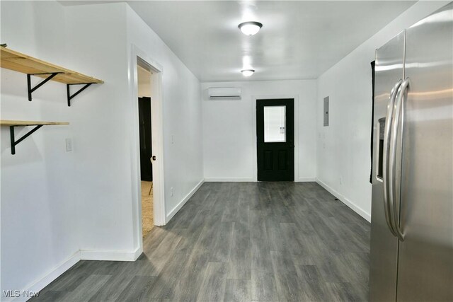 1553 Parkman Rd NW, Warren, OH 44485 - foyer entrance with an AC wall unit, baseboards, and dark wood-type flooring