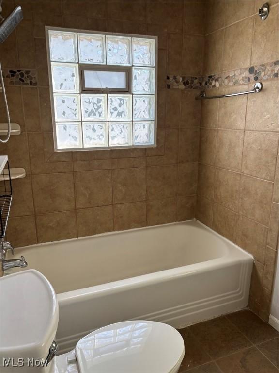 1104 S Belvoir Blvd, South Euclid, OH 44121 - bathroom featuring toilet, tile patterned floors, and washtub / shower combination