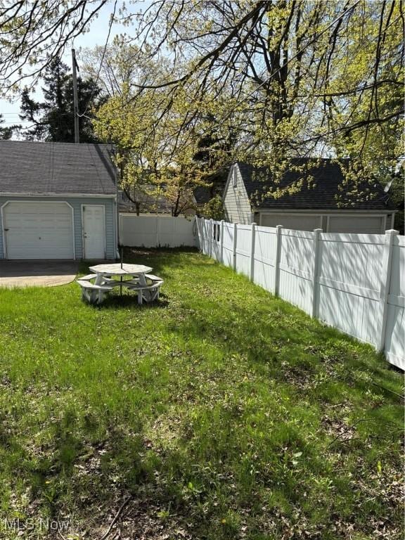 1104 S Belvoir Blvd, South Euclid, OH 44121 - view of yard featuring fence, an outdoor structure, and a garage