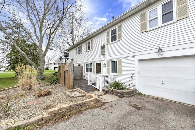 rear view of property featuring an attached garage