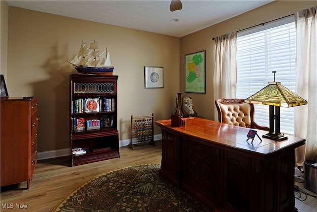 office with light wood-style floors and baseboards