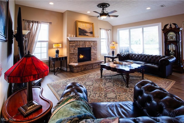 601 Cedar Crest Dr, Elyria, OH 44035 - living area with healthy amount of natural light, a ceiling fan, wood finished floors, a stone fireplace, and recessed lighting