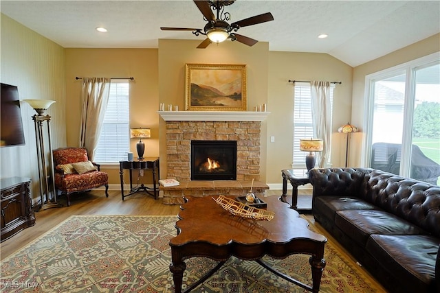 601 Cedar Crest Dr, Elyria, OH 44035 - living room featuring wood finished floors, ceiling fan, a fireplace, vaulted ceiling, and recessed lighting
