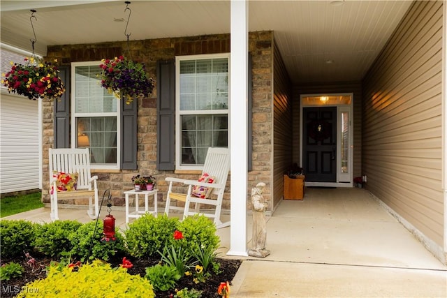 601 Cedar Crest Dr, Elyria, OH 44035 - doorway to property featuring a porch and stone siding