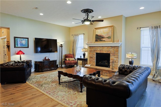 601 Cedar Crest Dr, Elyria, OH 44035 - living area with wood finished floors, a ceiling fan, a fireplace, and recessed lighting