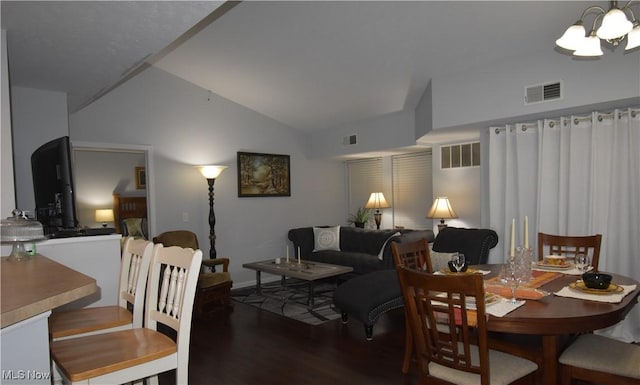 dining space featuring lofted ceiling, wood finished floors, and visible vents