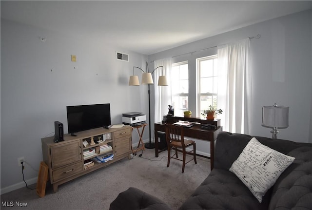 living area featuring visible vents, baseboards, and carpet floors