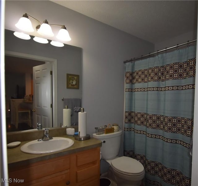 full bathroom with vanity, a shower with shower curtain, and toilet