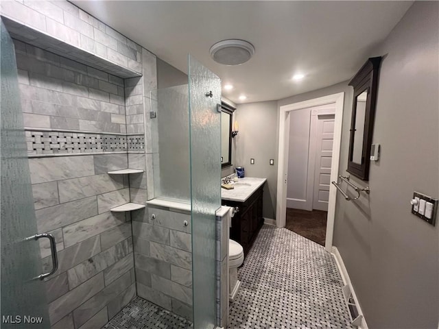 full bathroom featuring tile patterned flooring, vanity, recessed lighting, baseboards, and a stall shower