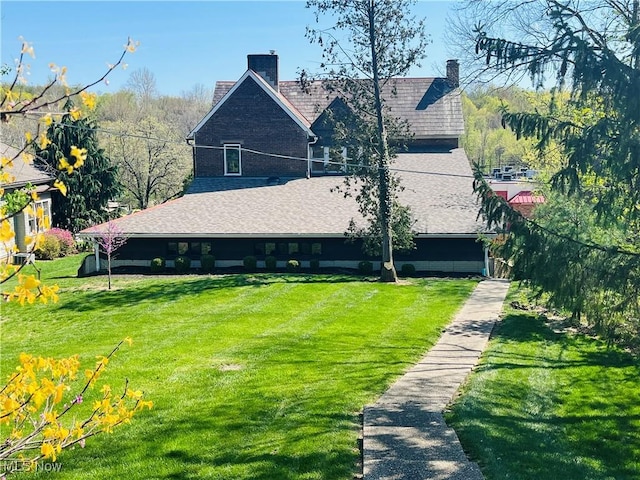 back of property with a yard and a chimney