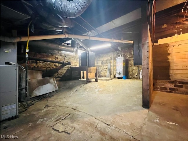 unfinished below grade area featuring water heater