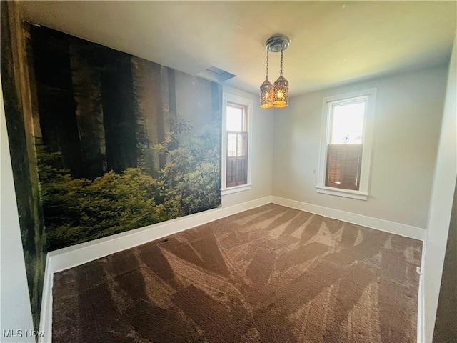 carpeted empty room with baseboards