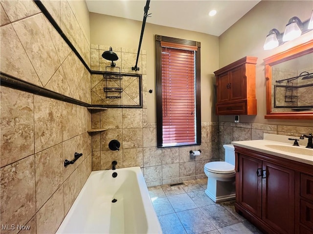 bathroom featuring toilet, tile walls, a tub to relax in, and vanity