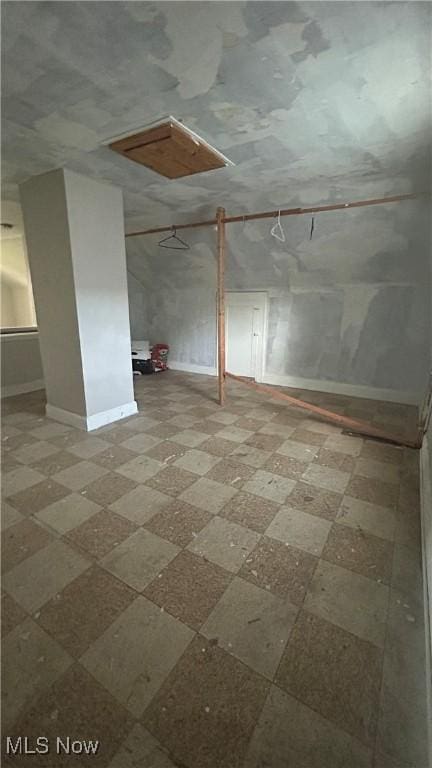additional living space featuring baseboards