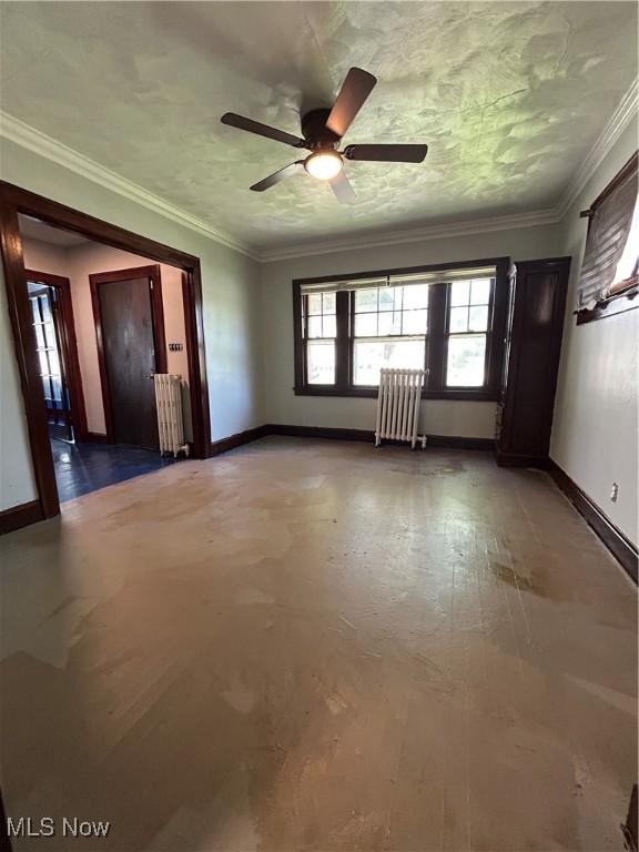 3370 E 102nd St, Cleveland, OH 44104 - unfurnished room with radiator heating unit, baseboards, ceiling fan, and crown molding
