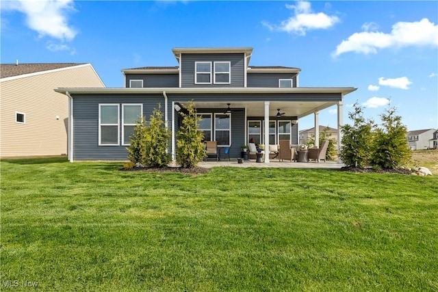 back of property featuring a patio, a ceiling fan, and a lawn