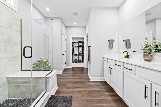 full bath with vanity, a shower stall, recessed lighting, and wood finished floors
