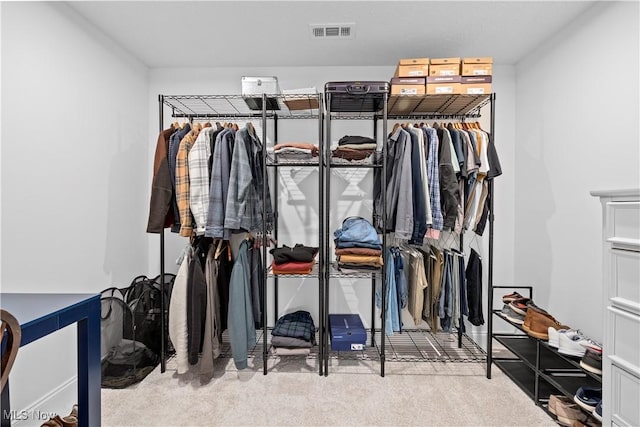 walk in closet with carpet floors and visible vents