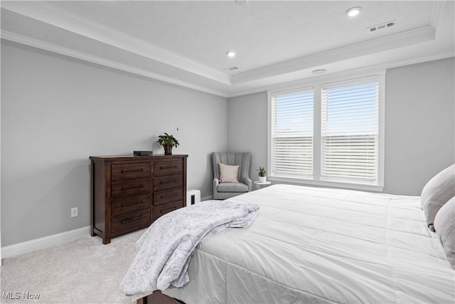 bedroom with visible vents, ornamental molding, a raised ceiling, and baseboards