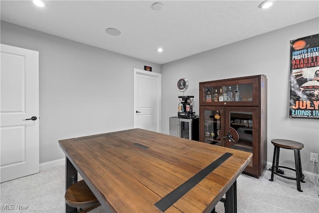 dining area featuring baseboards, recessed lighting, and light carpet