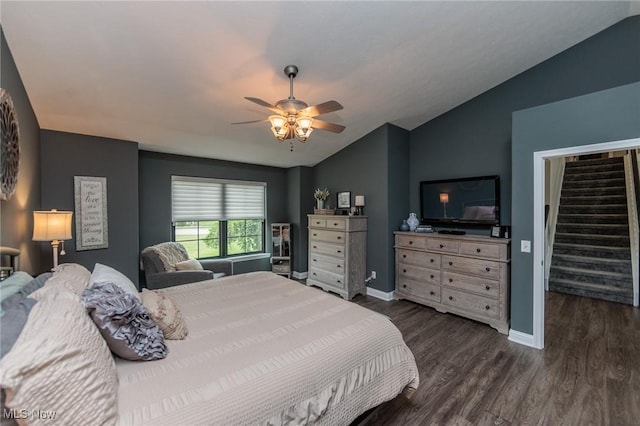 bedroom with baseboards, ceiling fan, wood finished floors, and lofted ceiling