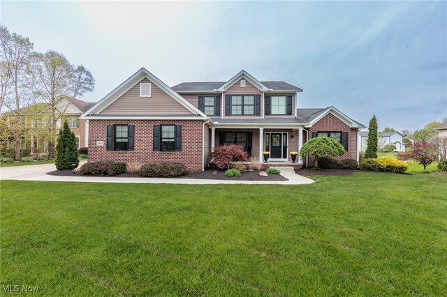 craftsman-style house with a front lawn and brick siding