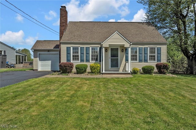 cape cod home with a garage, a front yard, a chimney, a shingled roof, and driveway
