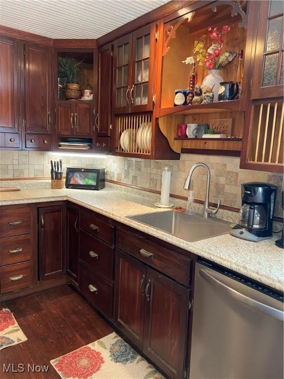 kitchen featuring open shelves, a sink, light countertops, tasteful backsplash, and stainless steel dishwasher