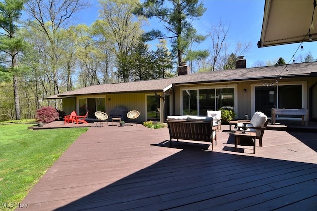 deck with a lawn and outdoor lounge area