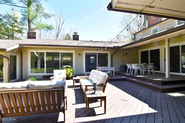 deck with outdoor dining area and an outdoor living space