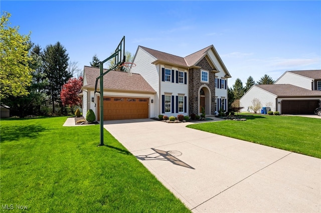 view of front of house with concrete driveway, a front yard, and a garage