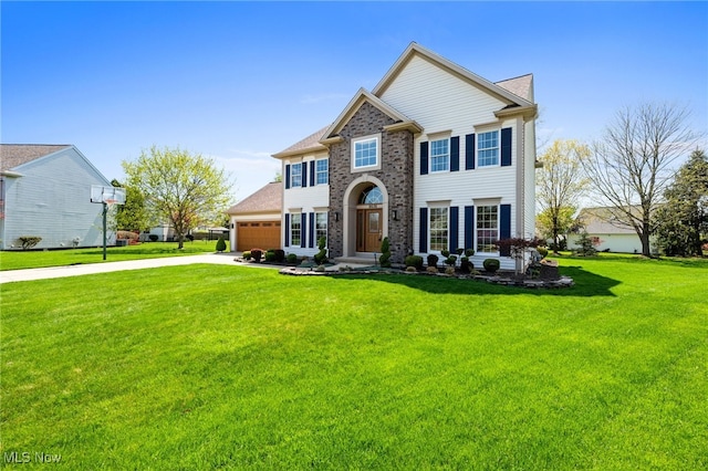 view of front of property featuring driveway, a front yard, and a garage