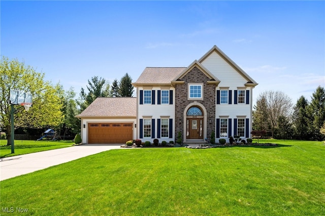 view of front of home featuring an attached garage, a front yard, and concrete driveway