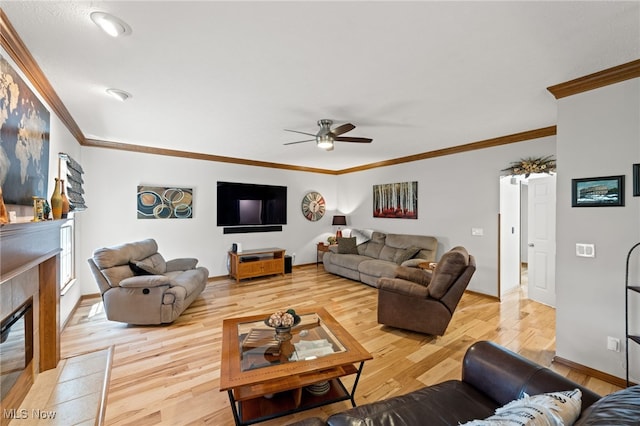 living area featuring crown molding, ceiling fan, and light wood-type flooring